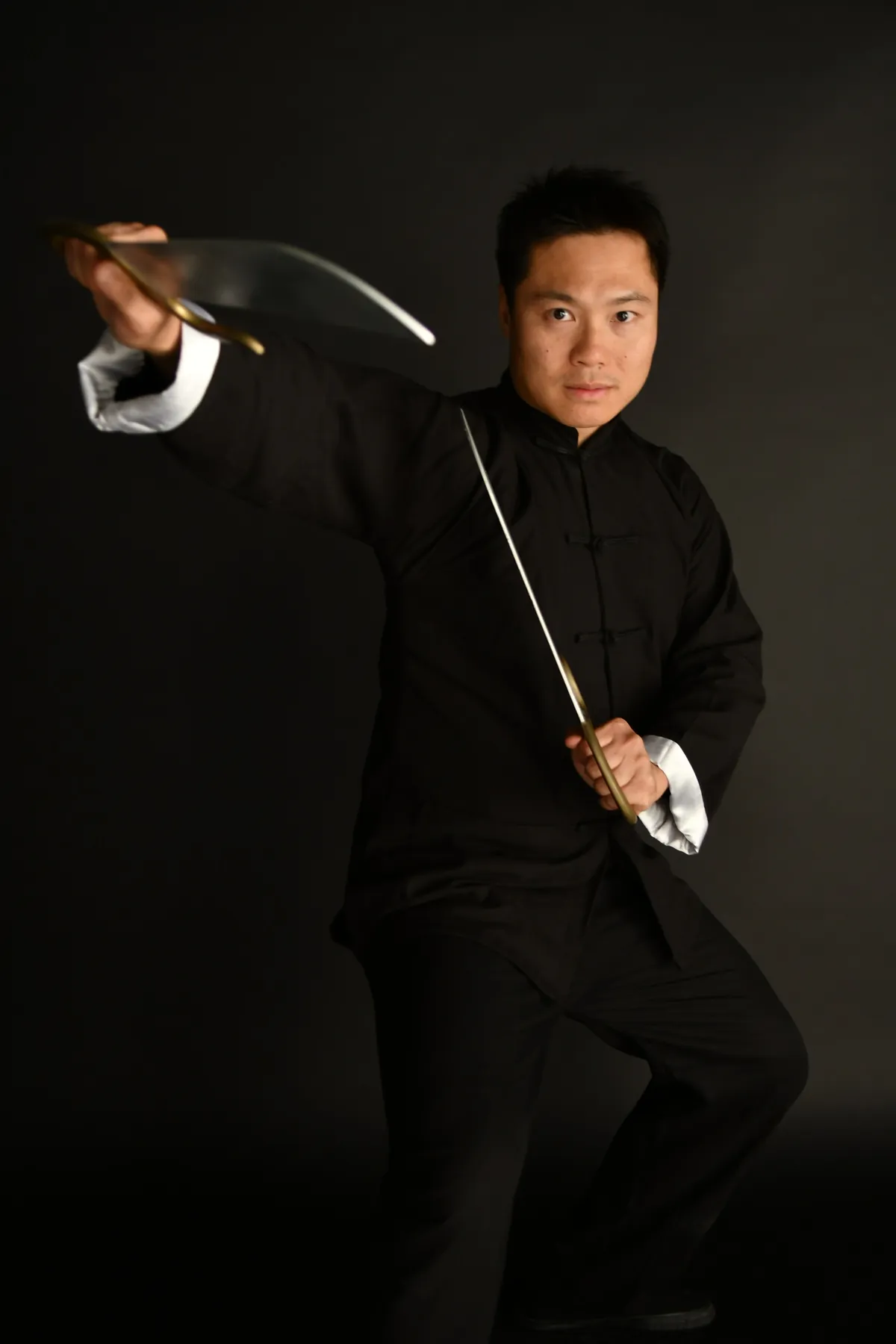 Master Leo Au-Yeung in a full-body Wing Chun stance with butterfly swords